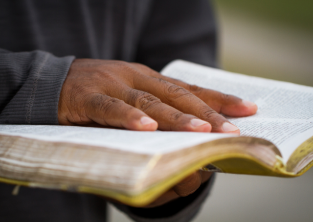 Hand on top of the book of Antigone