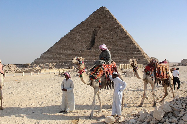 Men in front of a pyramid